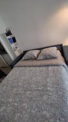 a bedroom with a bed with two pillows on it at Carré d'Or - Studio lumineux à 5 minutes de la plage in Nice