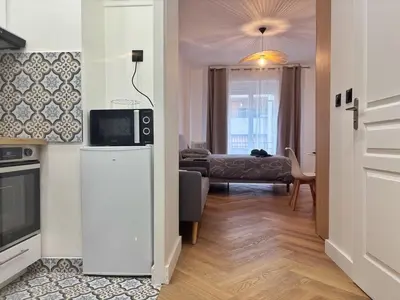 a living room with a television on top of a refrigerator at Charming apartment in Nice in Nice