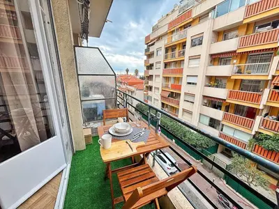 a balcony with a table and chairs on a balcony at Charming apartment in Nice in Nice
