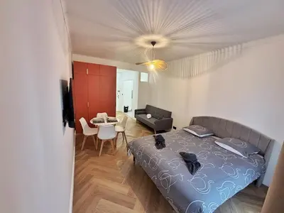a bedroom with a bed and a living room at Charming apartment in Nice in Nice