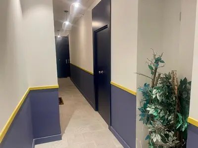 a hallway with blue and white walls and a black door at Suite ana in Nice
