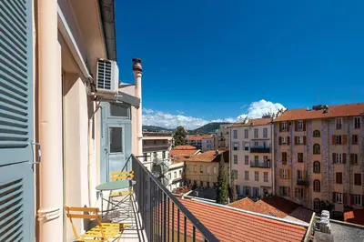 a balcony with chairs and a view of a city at Suite ana in Nice