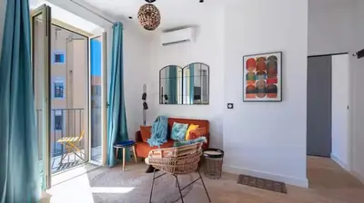 a living room with a couch and a balcony at Suite ana in Nice