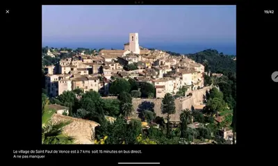 a village on top of a hill with a tower at Echappèe belle en bord de mer in Cagnes-sur-Mer