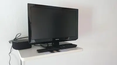 a computer monitor sitting on top of a table at Studio-mezzanine dans villa in Cagnes-sur-Mer