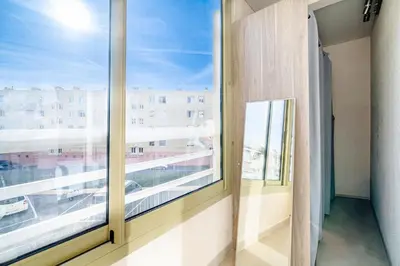 a room with a large window with a view of a city at 2 pièces Calme Proche de la mer Parking en sous-sol in Cagnes-sur-Mer
