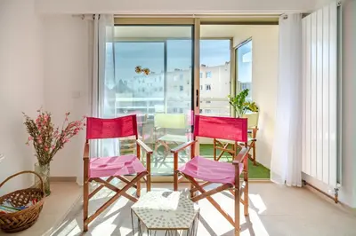 a room with three chairs and a balcony with a view at 2 pièces Calme Proche de la mer Parking en sous-sol in Cagnes-sur-Mer