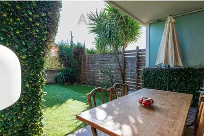 a table and chairs with a table and an umbrella at Nice Absea Belles Terres Studio in Nice