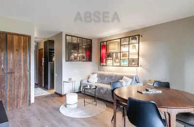 a living room with a couch and a table at Nice Absea Belles Terres Studio in Nice