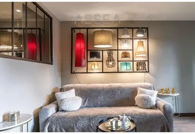 a living room with a couch and a table at Nice Absea Belles Terres Studio in Nice