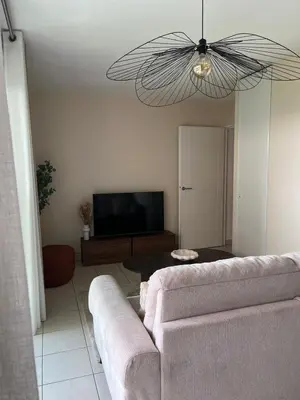 a living room with a couch and a flat screen tv at Nice french Riviera, parking gratuit, Tram L1 AU PIED de l'immeuble in Nice