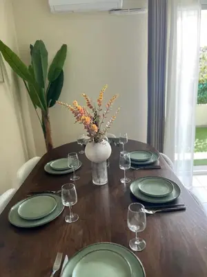 a wooden table with green plates and wine glasses at Nice french Riviera, parking gratuit, Tram L1 AU PIED de l'immeuble in Nice