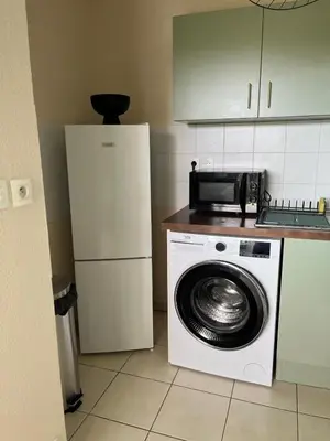 a kitchen with a washing machine and a refrigerator at Nice french Riviera, parking gratuit, Tram L1 AU PIED de l'immeuble in Nice