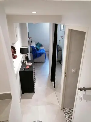 a hallway leading to a living room with a couch at Joli studio à Nice in Nice