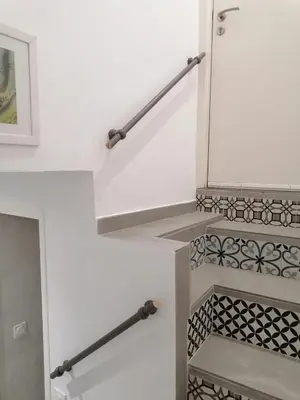 a white staircase with black and white tile at Joli studio à Nice in Nice