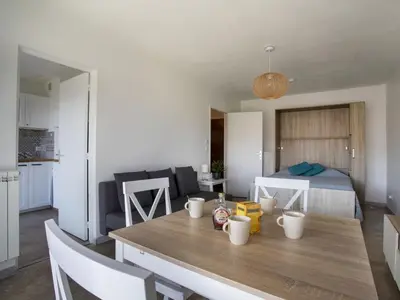 a kitchen and living room with a table and a bed at Apartment Cagnes Provencal by Interhome in Cagnes-sur-Mer