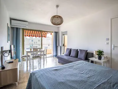 a bedroom with a bed and a couch and a table at Apartment Cagnes Provencal by Interhome in Cagnes-sur-Mer