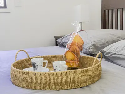 a basket with cups and a bag on a bed at Apartment Prestige view by Interhome in Èze