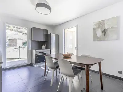 a kitchen and dining room with a table and chairs at Apartment Prestige view by Interhome in Èze