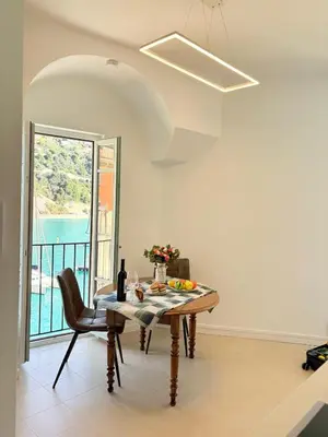 a dining room with a table and a window at NEPTUNE AP4453 By Riviera Holiday Homes in Villefranche-sur-Mer