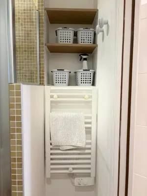 a white cabinet with a towel in a bathroom at NEPTUNE AP4453 By Riviera Holiday Homes in Villefranche-sur-Mer
