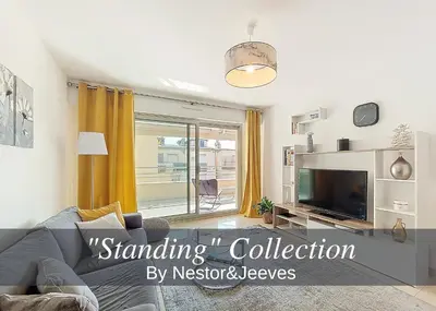 a living room with a couch and a tv at Nestor&Jeeves - LE BACCARA - Terrace - Central in Nice