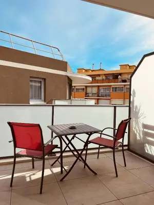 a patio with a table and chairs on a balcony at Cosy Apartment Vauban in Nice