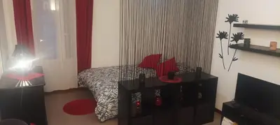 a bedroom with a bed with red pillows at F1 Cozy & Stylish in Hyper-Centre in Nice