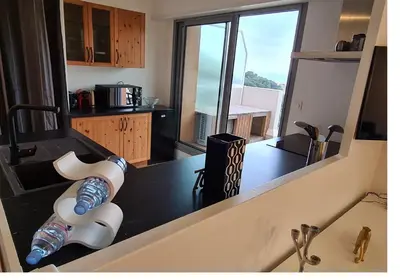 a kitchen with a counter with two water bottles on it at Magnifique vue mer - Piscine -Tennis in Nice