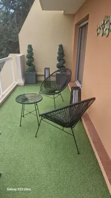 a patio with two chairs and a table on a balcony at Magnifique vue mer - Piscine -Tennis in Nice