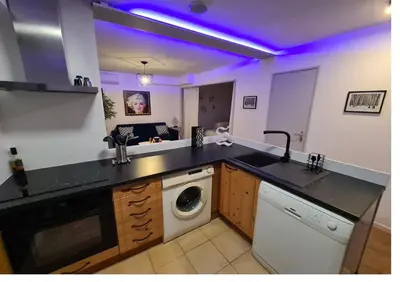 a kitchen with a sink and a washing machine at Magnifique vue mer - Piscine -Tennis in Nice