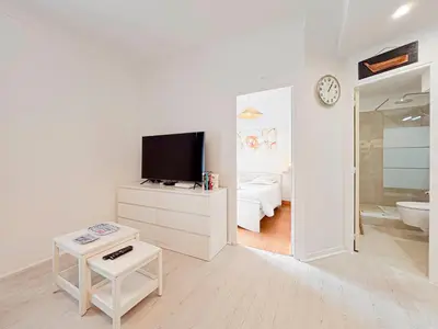 a white room with a television and a bathroom at Charmant 2P près du Negresco et de la plage - 3pers in Nice