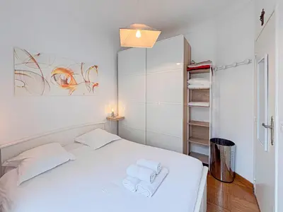 a white bedroom with a bed with towels on it at Charmant 2P près du Negresco et de la plage - 3pers in Nice