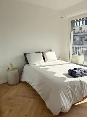 a white bed in a room with a large window at Port de Nice, Appartement 4pers emplacement idéal tout équipé balcon in Nice