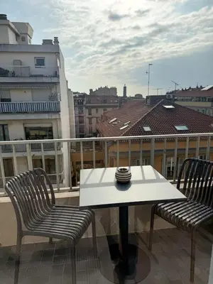 a white table and two chairs on a balcony at Port de Nice, Appartement 4pers emplacement idéal tout équipé balcon in Nice