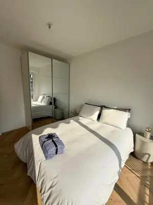 a large white bed in a room with a mirror at Port de Nice, Appartement 4pers emplacement idéal tout équipé balcon in Nice