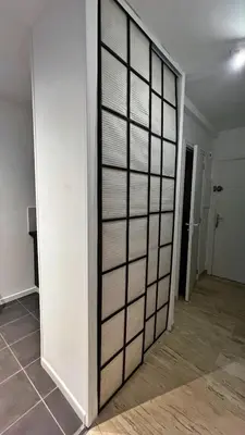 a room with a white wall with glass panels at Le Ciel in Nice