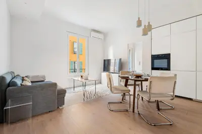a living room with a table and a couch at Appartement Ostave - Welkeys in Nice