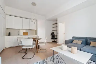 a living room with a blue couch and a table at Appartement Ostave - Welkeys in Nice
