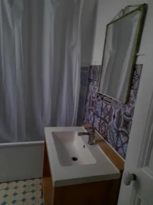 a bathroom with a sink and a mirror at Appartement près des plages in Nice