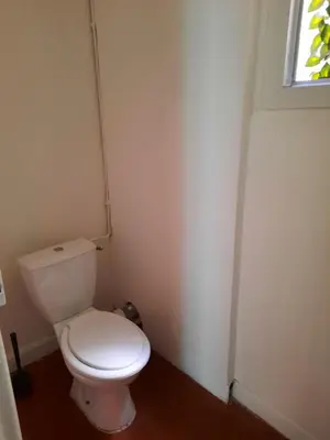 a white toilet in a bathroom with a window at Appartement près des plages in Nice