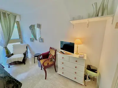 a bedroom with a bed and a desk with a television at A G Cocon Massenet - Grimaldi - Promenade des Angl in Nice