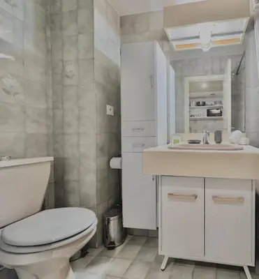 a white bathroom with a toilet and a sink at A G Cocon Massenet - Grimaldi - Promenade des Angl in Nice