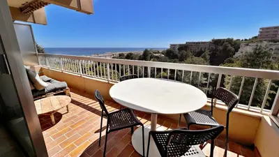 a balcony with a table and chairs and the ocean at Vista Mare in Nice