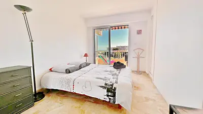 a bedroom with a large bed and a window at Vista Mare in Nice