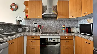 a kitchen with wooden cabinets and a stove top oven at Vista Mare in Nice