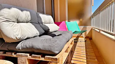 a large couch sitting on top of a balcony at Vista Mare in Nice