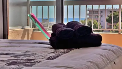 a pile of rolls of yarn sitting on top of a bed at Vista Mare in Nice
