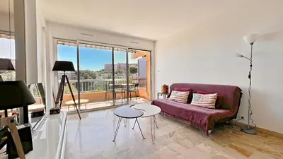 a living room with a purple couch and a table at Vista Mare in Nice