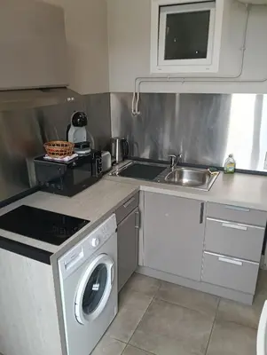 a kitchen with a washing machine and a sink at Studio central Nice in Nice